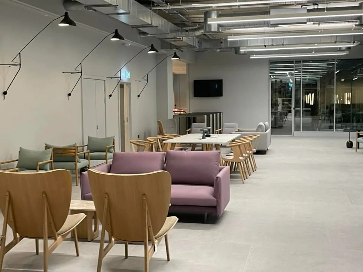 Finished modern commercial lounge area with designer furniture pendant lights and polished concrete floor